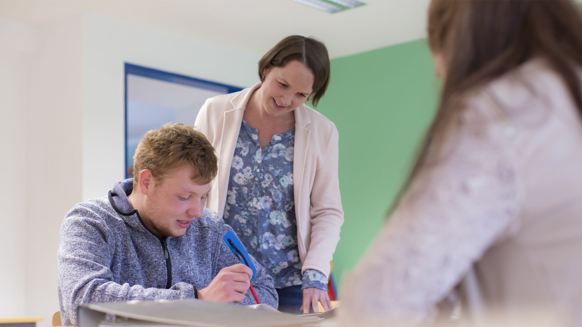 Schüler der BV-Klasse wird von Lehrerin unterrichtet